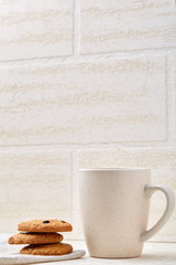 Close-up white cup of coffee with chocolate chip cookies on white background, top view