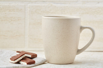 Close-up white cup of coffee with chocolate on white background, top view