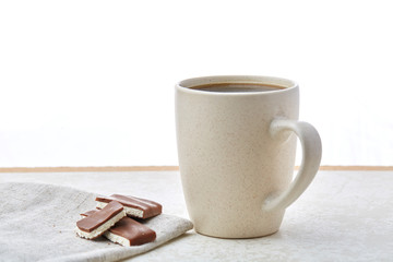 Close-up white cup of coffee with chocolate on white background, top view