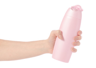 Shower gel in pink plastic bottle in hand