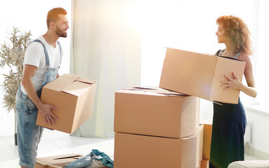 Young family unpacking boxes in a new house.