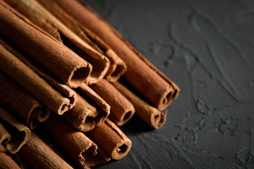  shelves of cinnamon in dark colors on a dark concrete stone background