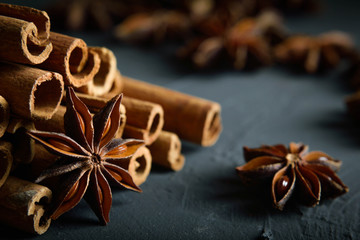  shelves of cinnamon and anise stars in dark colors on a dark concrete stone background