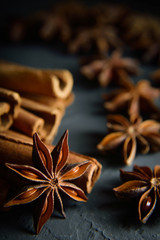  shelves of cinnamon and anise stars in dark colors on a dark concrete stone background