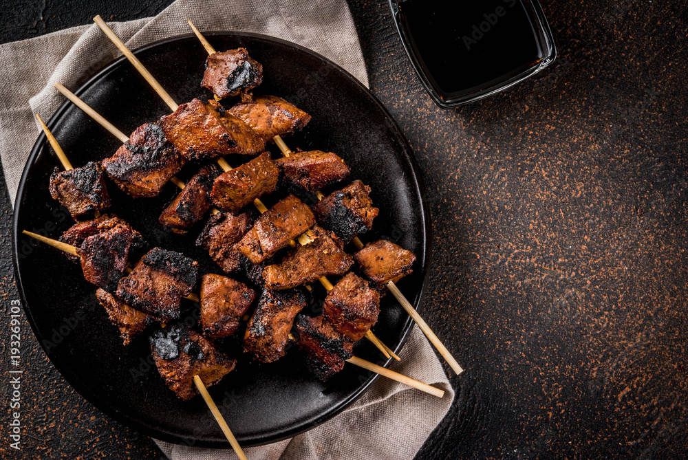 Wall mural grilled beef liver on skewers, with teriyaki or soy sauce, yakitori, dark rusty table copy space top