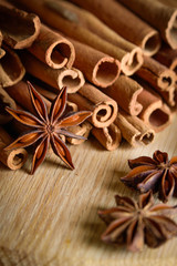  shelves of cinnamon and anise stars in dark backgrounds on a wooden background