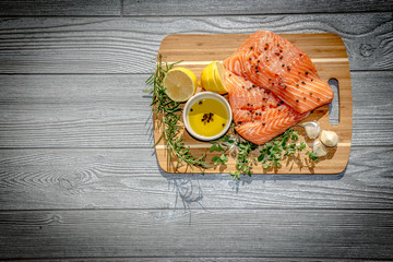 Fresh ingredients for Italian style salmon filet with garlic olive oil rosemary and oregano