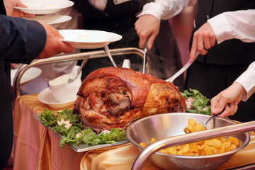 Roasted meat and baked potatoes at the party