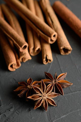  shelves of cinnamon and anise stars in dark colors on a dark concrete stone background