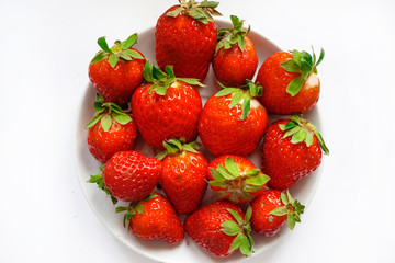 fresh strawberry on saucer on white background