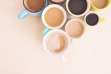 Obraz na płótnie Canvas A lot of coffee cups on the beige background