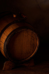 a small wooden wine bar, barrel on the legs and a wooden crane on a wooden background