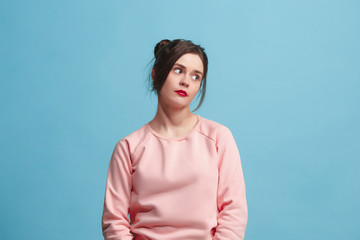 Beautiful bored woman bored isolated on blue background