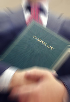 Lawyer holding a Criminal Law book