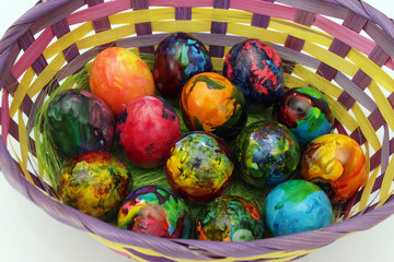 Easter eggs. Handmade painted eggs in basket for Easter celebration isolated on white background. Easter. Colored Easter eggs. Colorful egg. Copy space. Text space. Unique handmade painted eggs