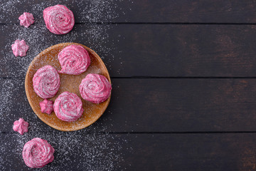 Meringues cookies on wooden plate