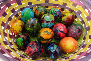 Easter eggs. Handmade painted eggs in basket for Easter celebration isolated on white background. Easter. Colored Easter eggs. Colorful egg. Copy space. Text space. Unique handmade painted eggs