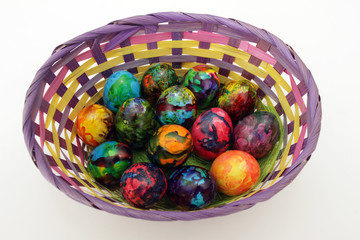 Easter eggs. Handmade painted eggs in basket for Easter celebration isolated on white background. Easter. Colored Easter eggs. Colorful egg. Copy space. Text space. Unique handmade painted eggs