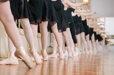 Fototapeta na wymiar Little ballerinas doing exercises ballet class.