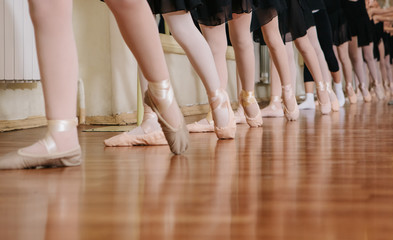 Little ballerinas doing exercises ballet class.