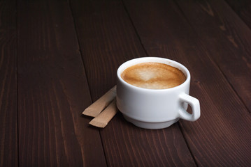 Cup of coffee on wooden background