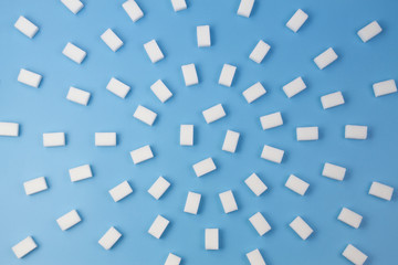 White sugar cubes on blue background