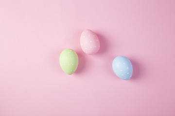 Fototapeta na wymiar Easter eggs background on the pink background 