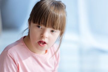 Portrait of thoughtful child with down syndrome