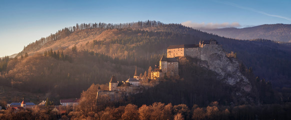 Beautiful sunset over Orava Castle - is situated on a high rock above Orava river in the village of...