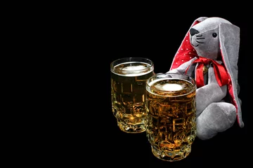 Foto auf Leinwand Easter bunny with two mugs of beer against black background © aquatarkus