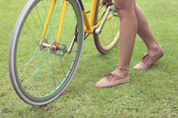 Fototapeta na wymiar Pretty woman standing with old retro bicycle outdoors.