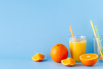 Orange juice on a blue pastel background