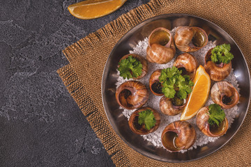Fried snails with lemon, baguette and parsley.