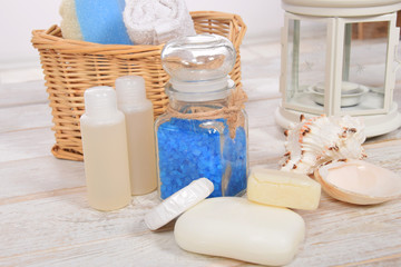 wicker basket with towel and sponge mini shampoo mini soap and sea salt with scallop with free space for text