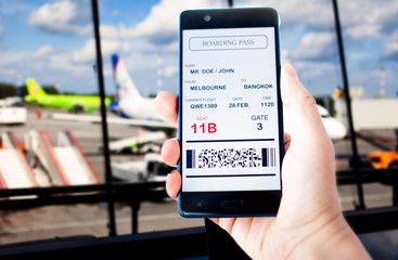Electronic boarding pass on the screen of smartphone. Concept of modern travel. Boarding pass is...