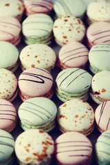 Colorful french macaroons flat lay. Pastel colors pink, green, yellow macarons with copy space, top view. Holidays and celebrations concept. Sweet gift for woman, girl. Banner