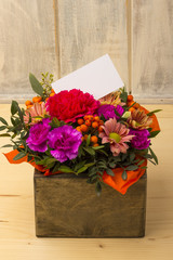 Image of fresh spring flowers with copy space. Bouquet of flowers with a white card 1