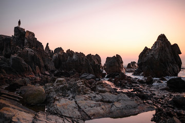 silhouette of man standing on the rock