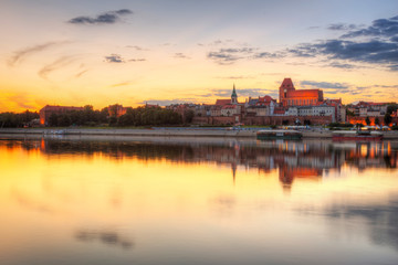 Torun old town over Vistula river at sunset, Poland