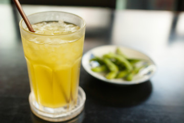 glass of iced green tea on black wooden table