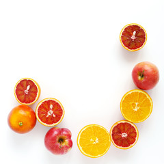 Creative flat layout of fruit, top view. Sliced red orange, apple  isolated on white background. Composition pattern of fresh fruits.	