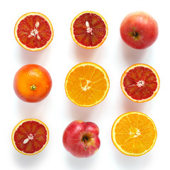 Creative flat layout of fruit, top view. Sliced red orange, apple  isolated on white background. Composition pattern of fresh fruits.	