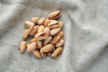 Pistachios on fabric cotton napkin, sallow depth of field, selective focus, top view, macro