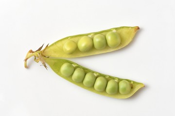 Bright and fresh peas, open pods with peas on a white background