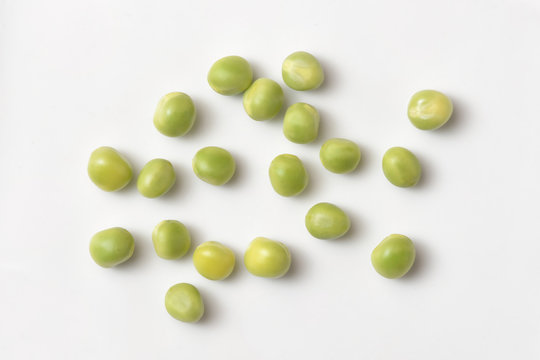 Bright and fresh peas, on white paper background