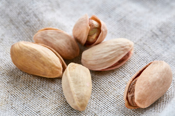 Pistachios on fabric cotton napkin, sallow depth of field, selective focus, top view, macro