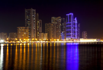 Skyscrapers on the shores of Laguna Khalid. Night view. Sharjah. United Arab Emirates