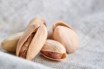 Pistachios on fabric cotton napkin, sallow depth of field, selective focus, top view, macro
