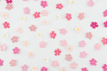 Fototapeta na wymiar Pink tone paper flowers horizontal pattern on white background