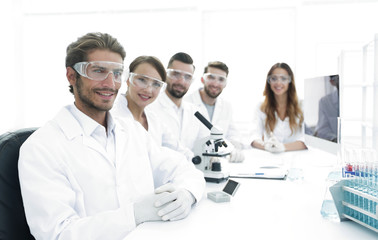 Male scientist and the team in the lab.